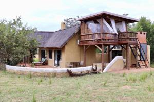 a house with a tree house with a slide at Bushveld Venue in Mabula +23 photos