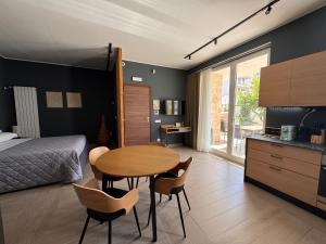 a bedroom with a bed and a table and chairs at Cristina Home in Taranto