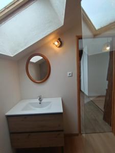 a bathroom with a sink and a mirror on the wall at Gîte MARISA in Champagney +31 photos