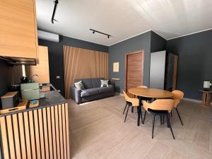 a living room with a table and chairs and a couch at Cristina Home in Taranto +16 photos