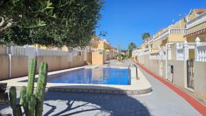 a swimming pool in the middle of a street with houses at CASA LUTHI Costa Blanca in Orihuela Costa