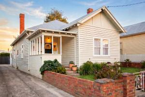 a white house with a brick wall at Central 3BR Heritage Home Walk to Sovereign Hill & CBD Free Parking in Ballarat