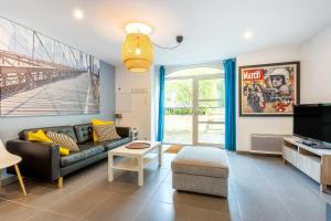 a living room with a couch and a tv at La Longère du Salou in Landrévarzec