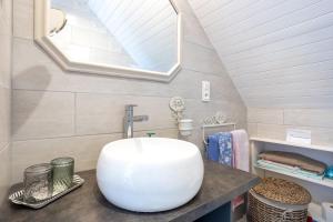 a bathroom with a white sink and a mirror at Ty Annick chambres d'hôtes in Névez +28 photos