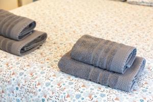 two towels sitting on top of a bed at La Longère du Salou in Landrévarzec +29 photos