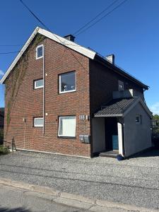 a red brick building with a garage at Loftsrom in Drammen