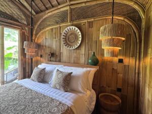 a bedroom with a bed with wooden walls and lights at Sweet Escape - Boutique Hotel in Sidemen