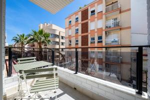 a balcony with two benches and a building at Sunrise Center Suites in Torrevieja