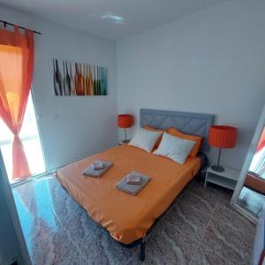 a bedroom with a bed with two towels on it at CASA LUTHI Costa Blanca in Orihuela Costa +11 photos