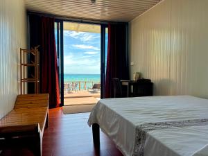 a bedroom with a bed and a view of the ocean at Crossa Inn in Siquijor +62 photos