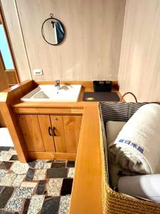 a small bathroom with a sink and a mirror at 夏日禾風會館 in Checheng