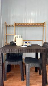 a table with two chairs and a telephone on it at Crossa Inn in Siquijor