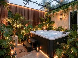 a jacuzzi tub in a garden with plants at SOLÉA Boutique Hotel & Spa- SaiGon in Ho Chi Minh City