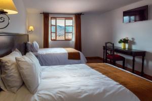 Ένα ή περισσότερα κρεβάτια σε δωμάτιο στο Illa Hotel