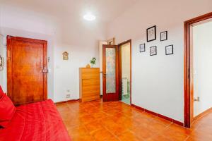 a living room with a red couch and a wooden door at Empoli, intero alloggio vicino Firenze in Empoli +8 photos