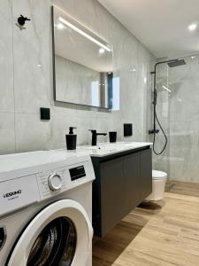 a bathroom with a washing machine and a sink at Celene Luxury Plakias in Plakias +49 photos