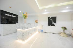 a white room with two vases on the wall at Global Hotel Pratunam Bangkok in Bangkok