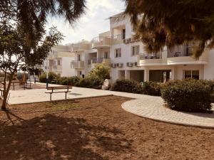 a building with a bench in front of it at Obv 2-303 in Pyla
