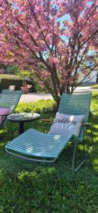 two lawn chairs and a table in front of a tree at Hotel Filser in Füssen +22 photos