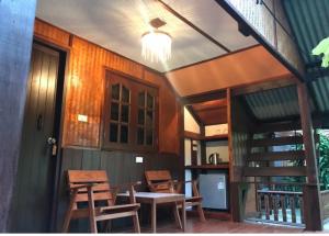 a dining room with wooden chairs and a table at Thai Terrace Bungalow in Thong Nai Pan Yai
