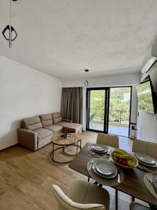 a living room with a couch and a table at Celene Luxury Plakias in Plakias