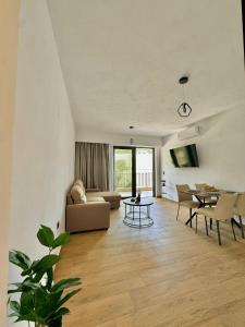 a living room with a couch and a table at Celene Luxury Plakias in Plakias