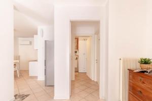 a kitchen with white walls and a refrigerator at Alle Porte in Vittorio Veneto