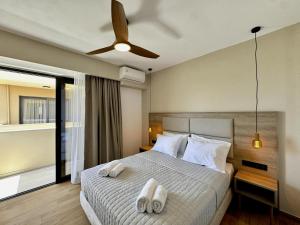 a bedroom with a bed with two towels on it at Celene Luxury Plakias in Plakias