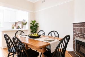 a dining room with a wooden table and chairs at Central 3BR Heritage Home Walk to Sovereign Hill & CBD Free Parking in Ballarat +7 photos