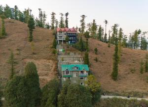 an aerial view of a house on a hill at Dancing Deer Chalet in Kūfrī +11 photos