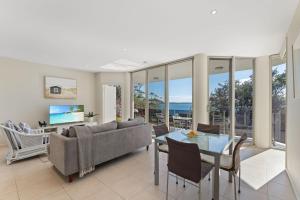 a living room with a couch and a table at Mirage 1 24 Gloucester Street in Nelson Bay