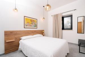 a bedroom with a white bed and a window at Case Vacanza Baglio Ciambre in Borgetto +74 photos