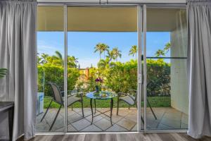 a patio with a table and chairs on a balcony at Napili Ridge K6 in Napili-Honokowai