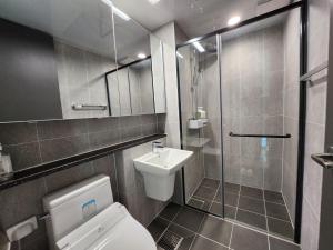 a bathroom with a toilet and a shower and a sink at 광안비치스테이&Spa in Kwangan-dong +14 photos