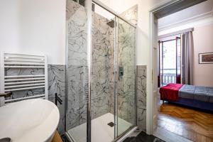 a bathroom with a shower with a glass door at Five Suites Mantellate 9 in Florence +70 photos