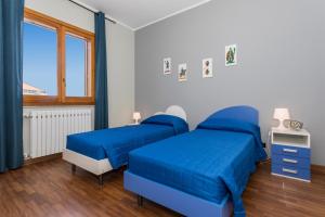 a bedroom with two beds and a window at Il Vulcano di Milo in Milo +36 photos