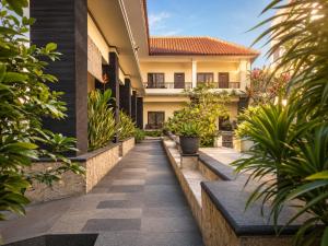 a courtyard of a house with plants at Radha Bali Hotel in Kuta