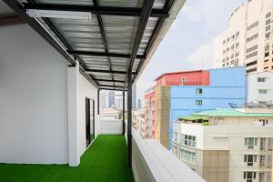 a view from the balcony of a building with green grass at Global Hotel Pratunam Bangkok in Bangkok