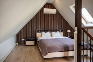 a bedroom with a bed in a attic at Cabin Guesthouse with free parking in Pärnu
