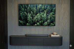 a table with a picture on a wall with trees at Hotel The Mount View in Rājgīr