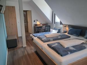 a bedroom with a large bed and a desk at Hotel Hirsch in Sinsheim +50 photos