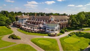 an aerial view of a large house on a golf course at The Belfry Hotel & Resort in Sutton Coldfield