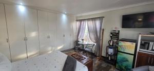 a living room with a couch and a table at 54 on Asteria 2 in Amanzimtoti