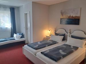 a bedroom with two beds in a room at Hotel Hirsch in Sinsheim