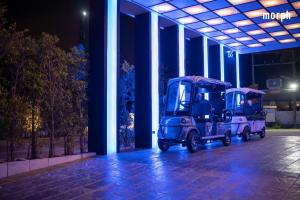 two blue scooters parked in a building at night at morph Bangkok Hotel in Bangkok