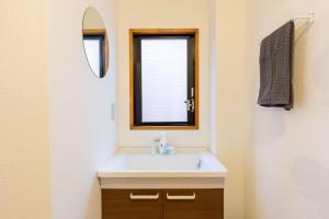 a bathroom with a sink and a mirror at 暖迎の宿 in Tokyo
