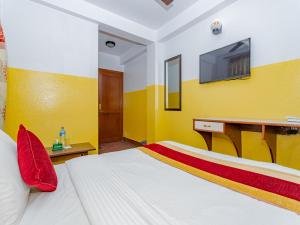 a bedroom with a bed with a tv on the wall at Tokyo Hotel in Kathmandu