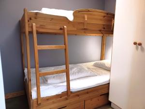 a bunk bed with a ladder in a room at AGO Nya Lundsgården in Åre
