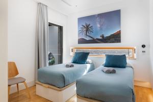 a bedroom with two beds and a window at Villa Liquen in Yaiza +33 photos