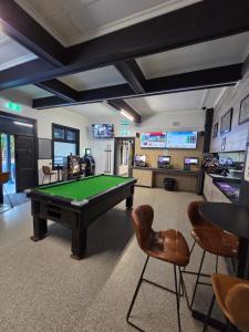 a billiard room with a pool table and chairs at The Rec Hotel Waroona in Waroona